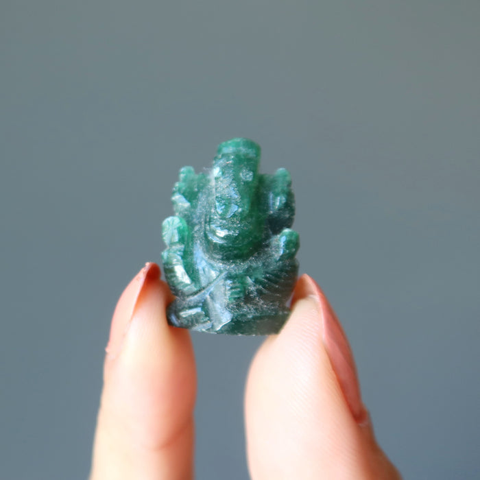 holding green aventurine ganesh