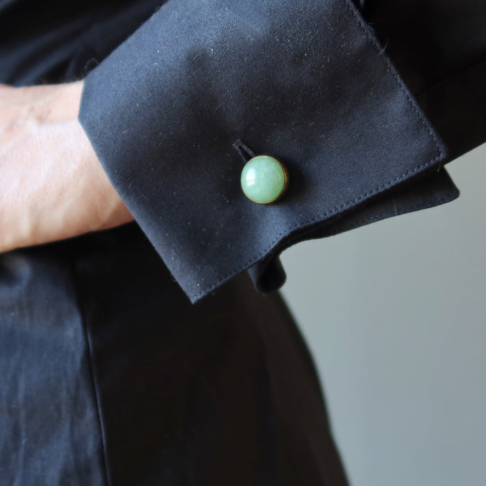 woman in black french cuff shirt wearing green aventurine cufflinks