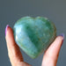 hand holding dark green aventurine heart