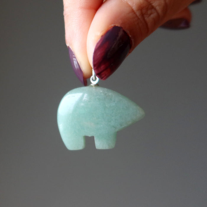 hand holding aventurine bear pendant