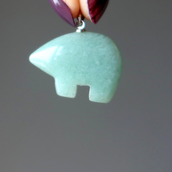 hand holding aventurine bear pendant