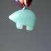 hand holding aventurine bear pendant