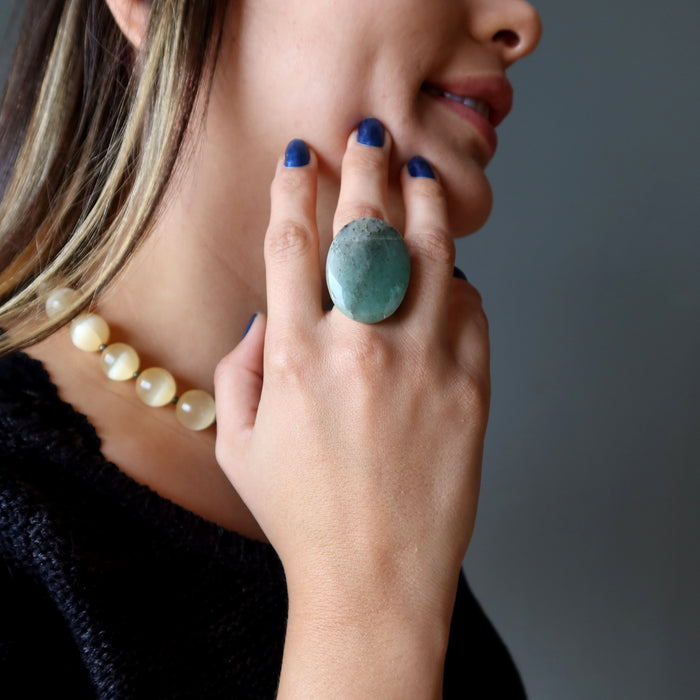 woman wearing large green aventurine oval ring