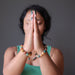 sheila of satin crystals with hands in prayer wearing multi colored aventurine stretch bracelets