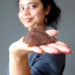 female holding red aventurine pyramid