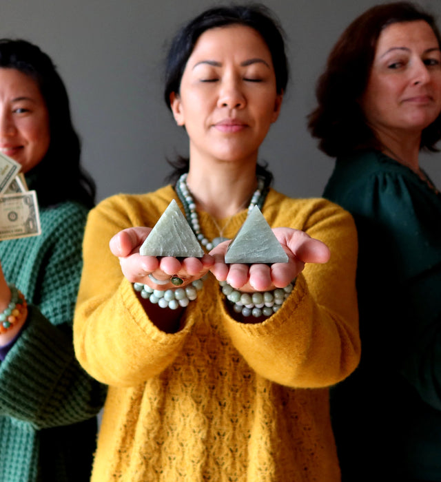 woman meditating with green aventurine pyramids