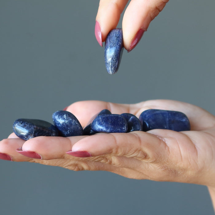 model holding Blue Aventurine Tumbled Stone Set