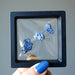 three raw azurite gemstone in case