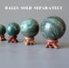 4 green aventurine spheres on set of 4 fancy crystal ball display stands in varying shades of brown wood sold separately
