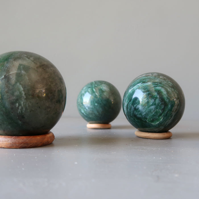 balls diaplying on 3 wooden ring stands 