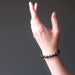 female hand modeling faceted bloodstone bracelet