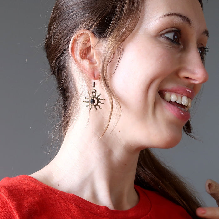 woman wearing bloodstone sun earrings
