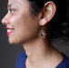 woman wearing bloodstone sun earrings