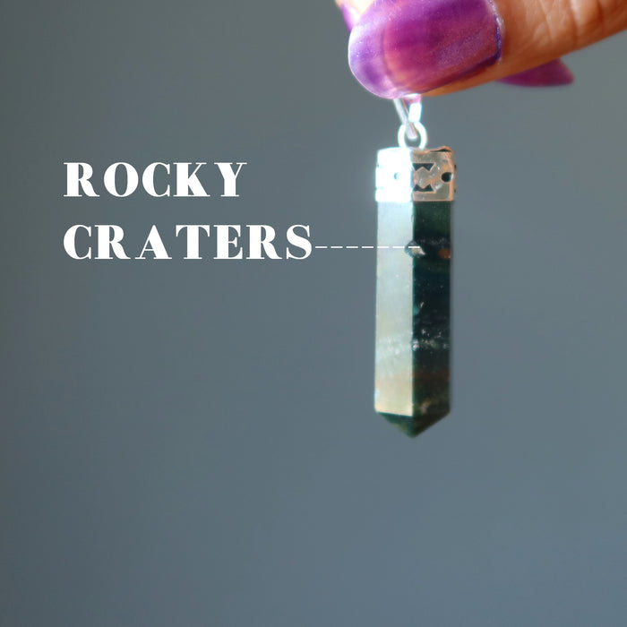 hand holding red and green bloodstone point pendant in silver showing rocky craters