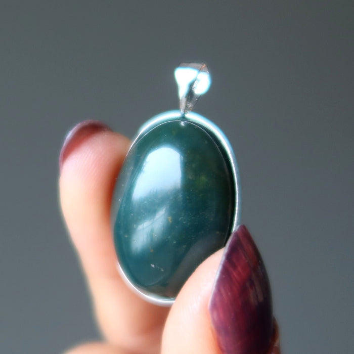 hand holding indian bloodstone pendant