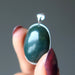 hand holding indian bloodstone pendant