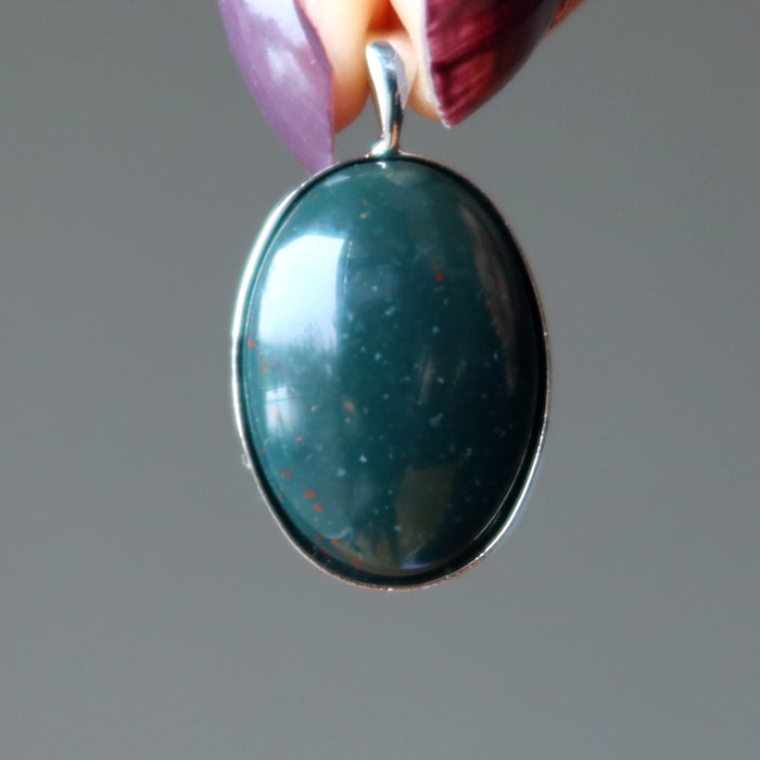 hand holding indian bloodstone pendant