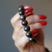 hand holding a bronzite bracelet