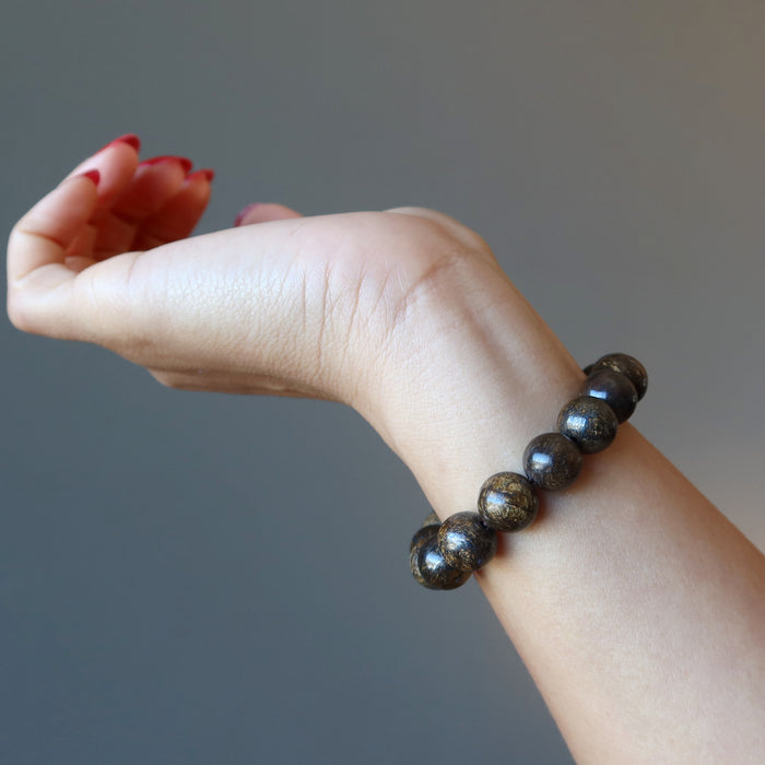 hand wearing a bronzite bracelet