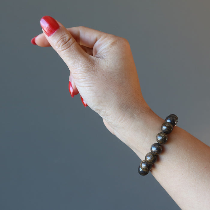 hand wearing a bronzite bracelet