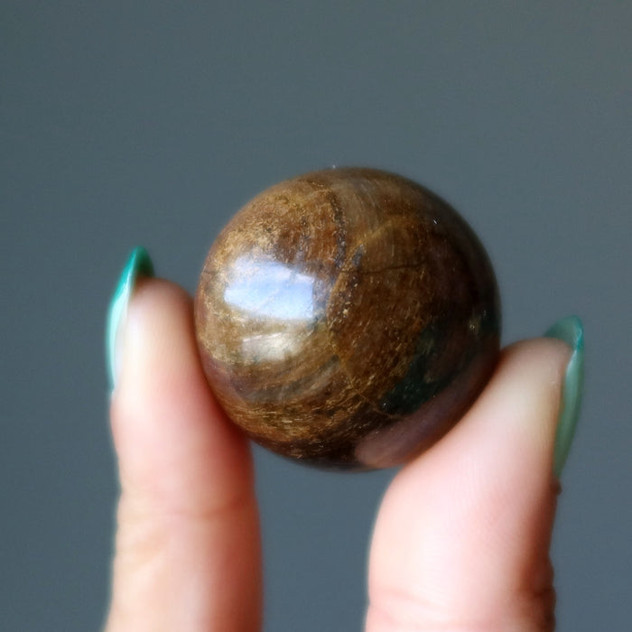 holding a Bronzite Sphere