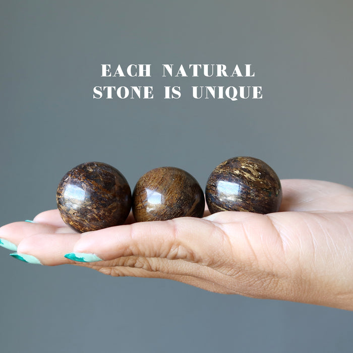 three Bronzite Sphere on the palm