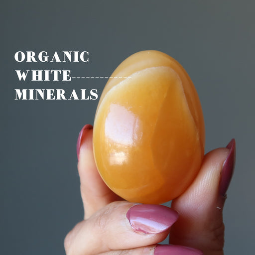 hand holding Golden Calcite Egg