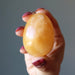 hand holding Golden Calcite Egg