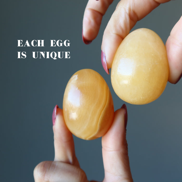 holding Golden Calcite Eggs one on each hand