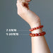 wrist wearing different size carnelian beads