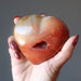 holding Orange Carnelian Heart with Cave