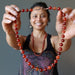 woman holding woman modeling carnelian copper beaded necklace