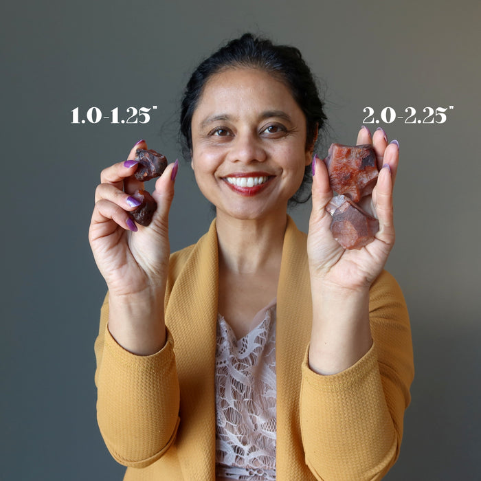 woman holding raw carnelian stone sets