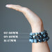 hand wearing three sizes of cats eye quartz bracelets