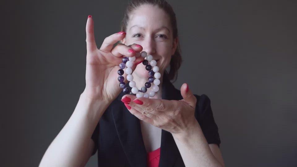 video of female model showcasing amethyst and rose quartz bracelets