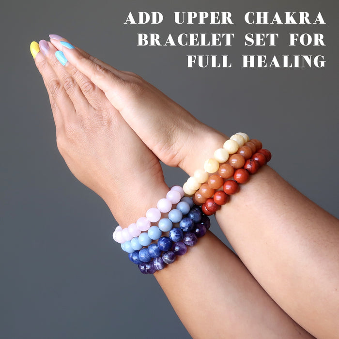 hands wearing the upper and the lower chakra bracelet sets