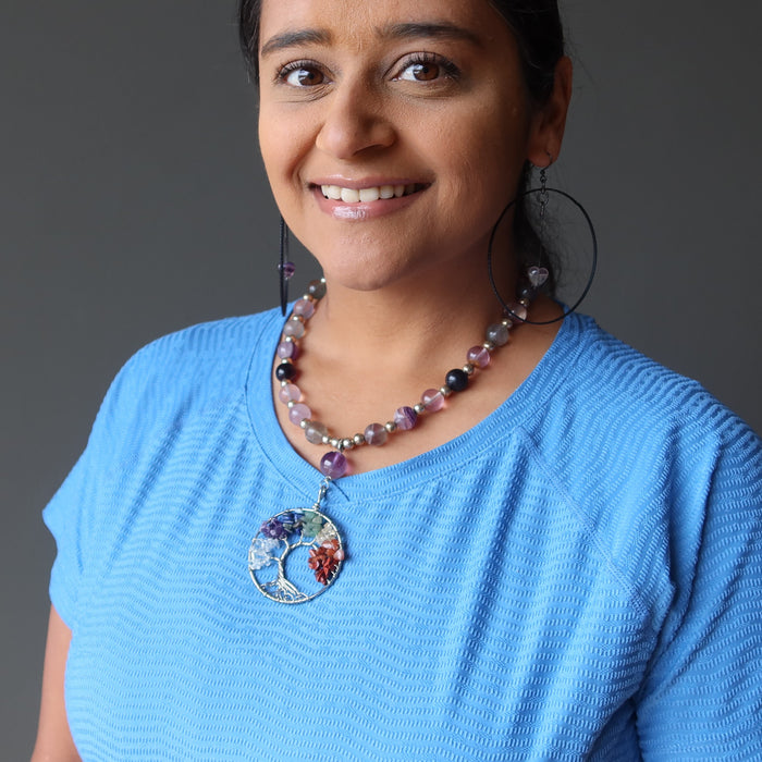 woman modeling rainbow fluorite chakra tree of life necklace