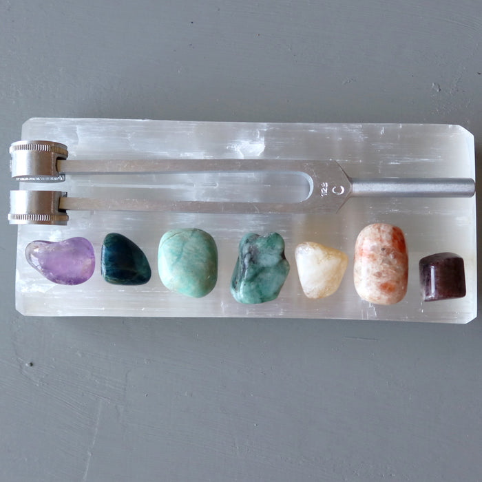 7 chakra stones and tuning fork set on selenite slab