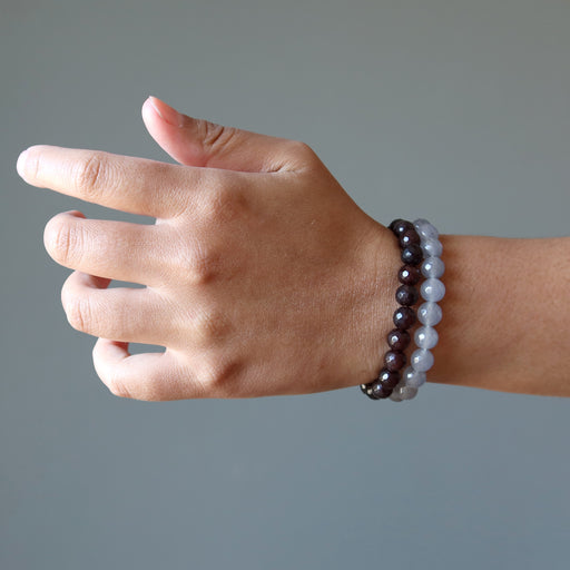 female hand modeling faceted gray and brown chalcedony beaded stretch bracelet set