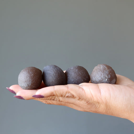 displaying on model palm 4 Brown Raw Chalcedony Gemstones 