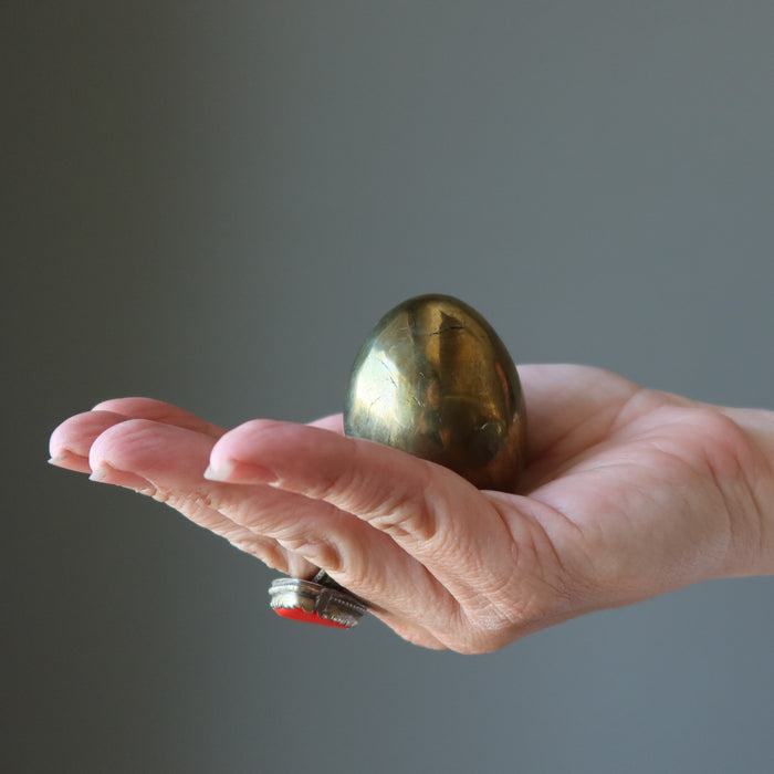 hand holding chalcopyrite egg
