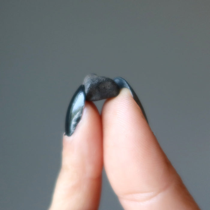 hand holding rocky brown chelyabinsk meteorite 