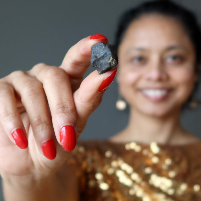 sheila of satin crystals holding rocky brown chelyabinsk meteorite 