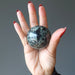 palm holding Green Tourmaline Sphere