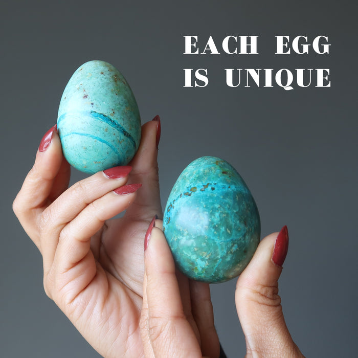 hands holding chrysocolla eggs