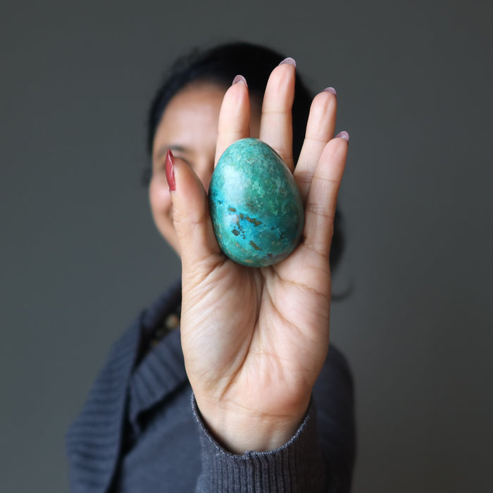 woman holding chrysocolla egg