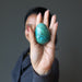 woman holding chrysocolla egg