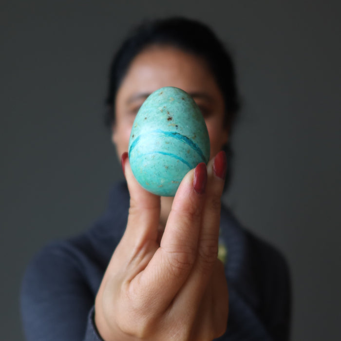 woman holding chrysocolla egg