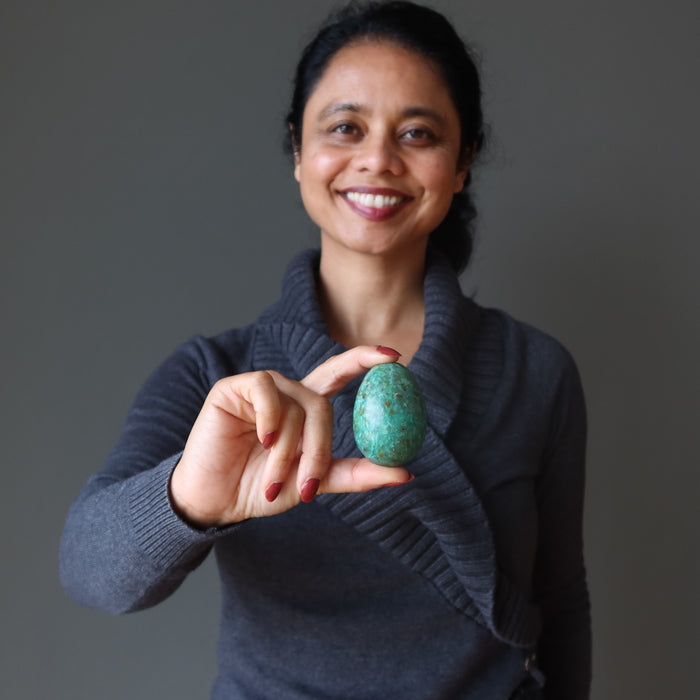 woman  with chrysocolla egg at heart chakra