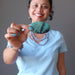sheila of satin crystals holding blue-green and black chrysocolla oval cabochon